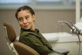 Little girl looking with fear sitting in a dental chair