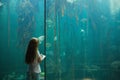 Little girl looking at fish tank Royalty Free Stock Photo