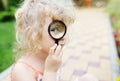 Little girl looking through a magnifying glass Royalty Free Stock Photo