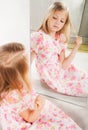Little girl looking at mirror, studio portrait Royalty Free Stock Photo