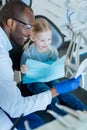 Little girl looking in the mirror after treatment at dentists Royalty Free Stock Photo