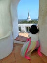 Little girl looking out from quiet top tower to big pagoda on Phra Nakhon Khiri Royal Palace, Phetchaburi, Thailand