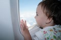 Little girl looking out window of airplane Royalty Free Stock Photo