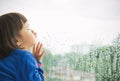 Little girl looking out of the window Royalty Free Stock Photo