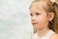 Little girl looking out the window on a rainy day Royalty Free Stock Photo