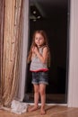 Little girl looking out window while standing on windowsill Royalty Free Stock Photo