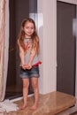 Little girl looking out window while standing on windowsill Royalty Free Stock Photo