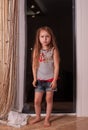 Little girl looking out window while standing on windowsill Royalty Free Stock Photo