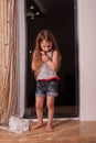 Little girl looking out window while standing on windowsill Royalty Free Stock Photo