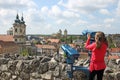 Little girl looking through sightseeing binoculars on Eger