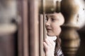 Little girl looking throw door window