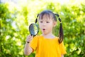 Little girl looking thru magnifying glass