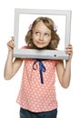 Little girl looking through the TV / computer screen frame Royalty Free Stock Photo