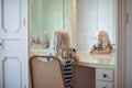 Little girl looking in vanity mirror in dressing room Royalty Free Stock Photo