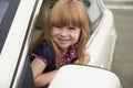 Little girl looks out the car window