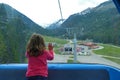 Little girl looks out the window of ski lift