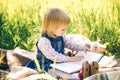 Little girl looks at pages of book Royalty Free Stock Photo