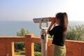 Little girl looks at the sea with a telescope at nanaodao island, adobe rgb Royalty Free Stock Photo