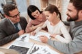 Little girl looks at test while sitting at table. Royalty Free Stock Photo