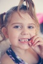 Little girl with loose tooth.