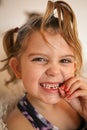 Little girl with loose tooth.