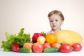 Little girl and a lot of fruit and vegetables.