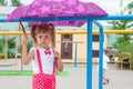 Little girl lovely baby with tails in the rain with umbrella Royalty Free Stock Photo