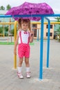 Little girl lovely baby with tails in the rain with umbrella Royalty Free Stock Photo