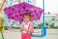Little girl lovely baby with tails in the rain with umbrella Royalty Free Stock Photo