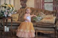 Little girl in the lush yellow with white dress