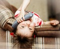 Little girl lying down talking on a wired phone Royalty Free Stock Photo