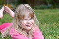 Little girl lying in grass Royalty Free Stock Photo