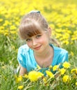 Little girl lying on grass in flower.