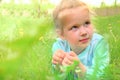 Little girl lying on grass lawn. Summer fun outdoors. Happy child enjoying on grass field and dreaming Royalty Free Stock Photo