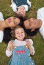 Little girl lying with her family in a park Royalty Free Stock Photo