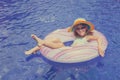 Little girl lying on the inflatable rubber circle in the swim