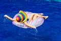 Little girl lying on the inflatable rubber circle in the swim