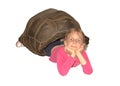 Little girl lying inside empty shell of a giant tortoise.White background isolated Royalty Free Stock Photo