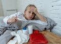 Little girl lying sick in bed feeling sick with high fever and headache having a cold flu Royalty Free Stock Photo