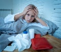 Little girl lying sick in bed feeling sick with high fever and headache having a cold flu Royalty Free Stock Photo