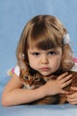 Little girl lying with somali kitten ruddy color Royalty Free Stock Photo