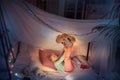 Little girl lying in a teepee, playing with the flashlight Royalty Free Stock Photo