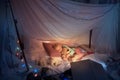 Little girl lying in a teepee, sleeping with the flashlight Royalty Free Stock Photo