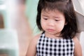 Little girl made a sad face from regret. Asian children bend their heads to cry. There are tears in eyelashes.