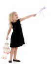 A little girl with a magic wand. Royalty Free Stock Photo