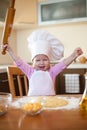 Little girl makes dough on kitchen Royalty Free Stock Photo