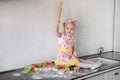 Little girl makes dough on kitchen with rolling pin Royalty Free Stock Photo