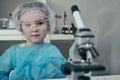 Little girl makes scientific experiments with chemical and biological products in her home laboratory. Royalty Free Stock Photo