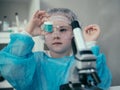 Little girl makes scientific experiments with chemical and biological products in her home laboratory. Royalty Free Stock Photo