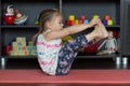 Little girl making boat yoga pose indoor Royalty Free Stock Photo